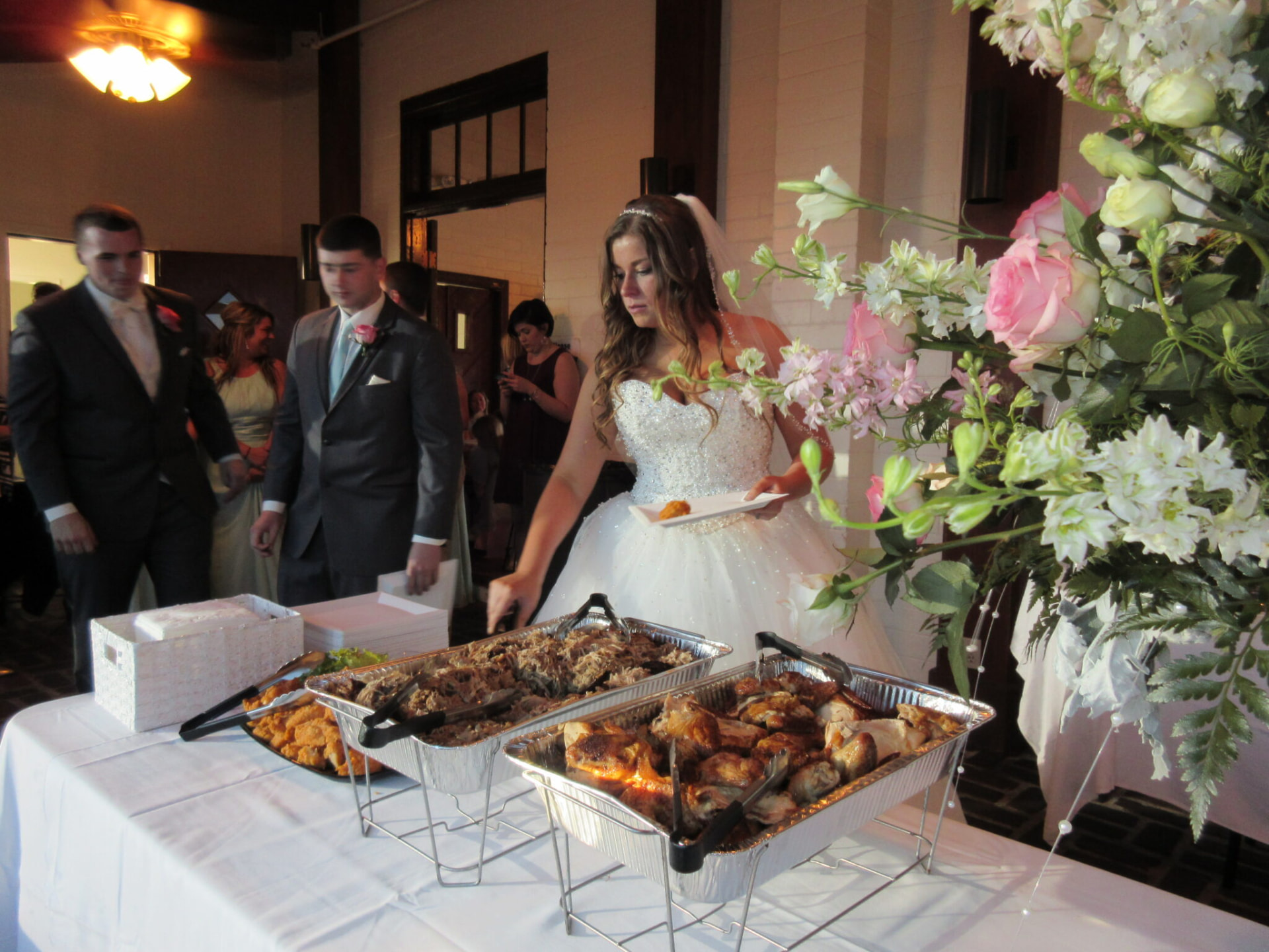 Wedding guests being served from a GrillBilly's catering buffet