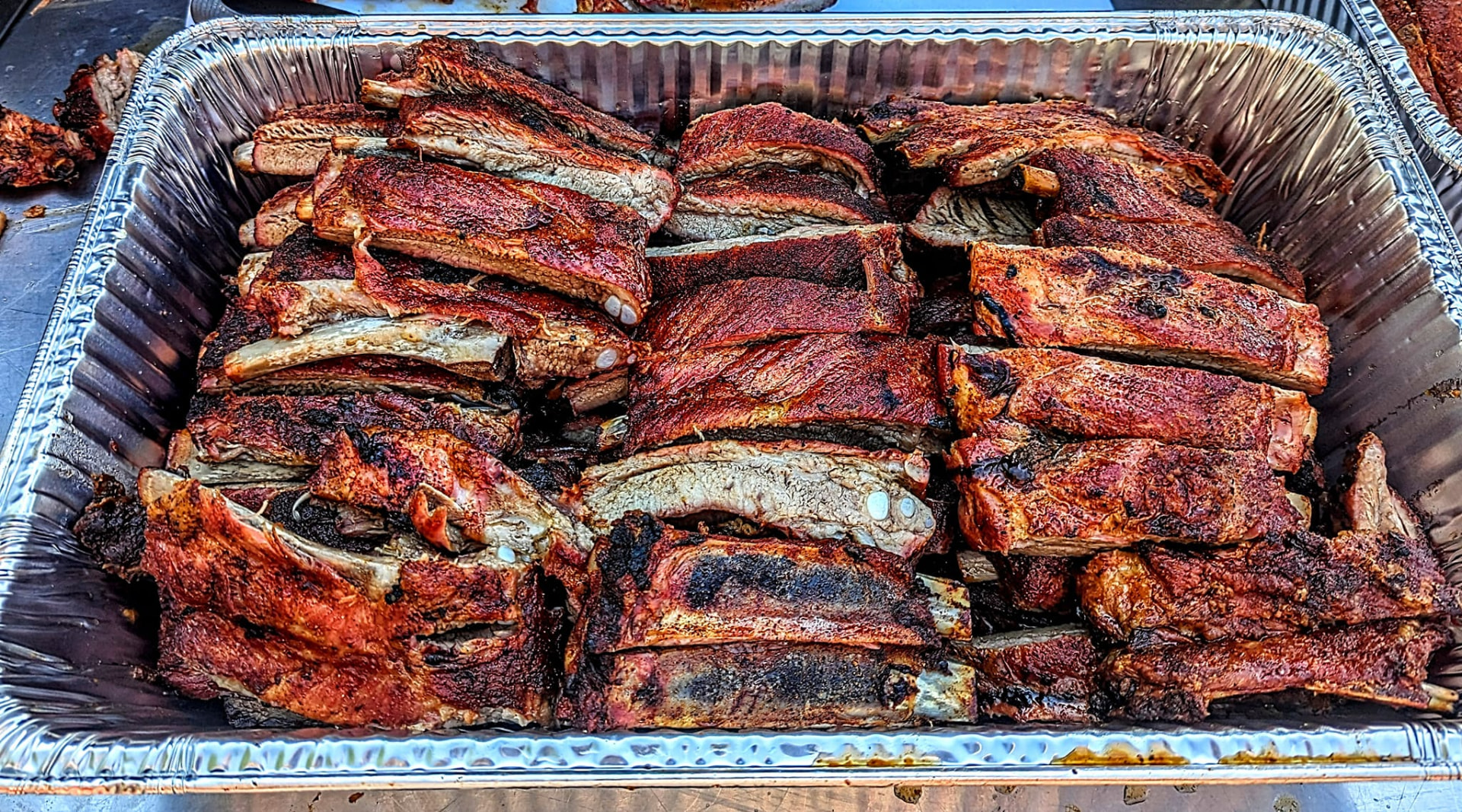 Freshly cut GrillBilly's ribs in a catering tray