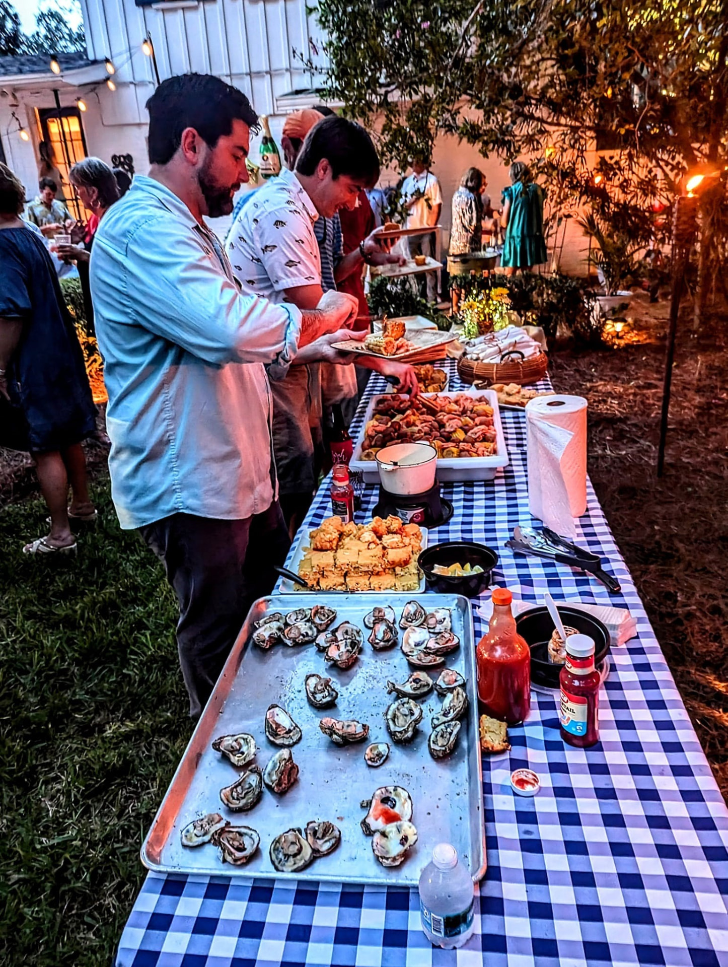Guests enjoying a GrillBilly's low country boil outdoors